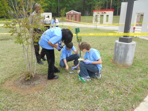 CSO-CSI photo of students looking for clues at CSI camp